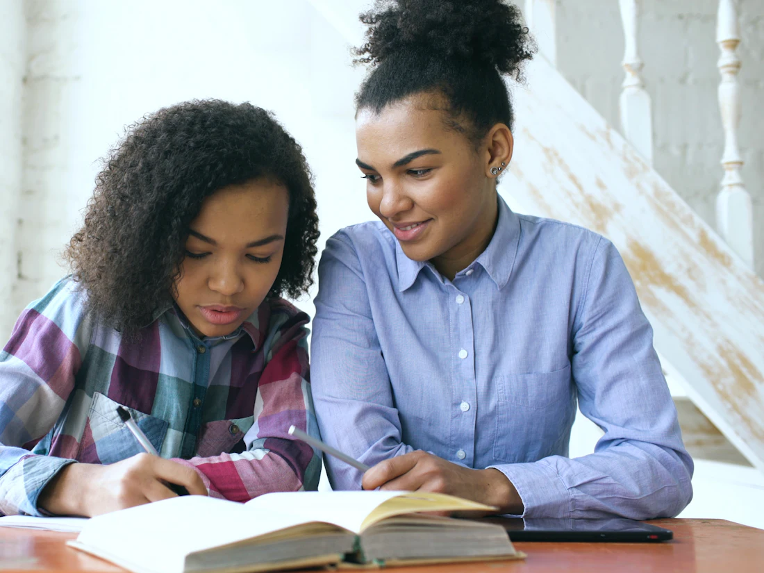 Two students studying together at a table